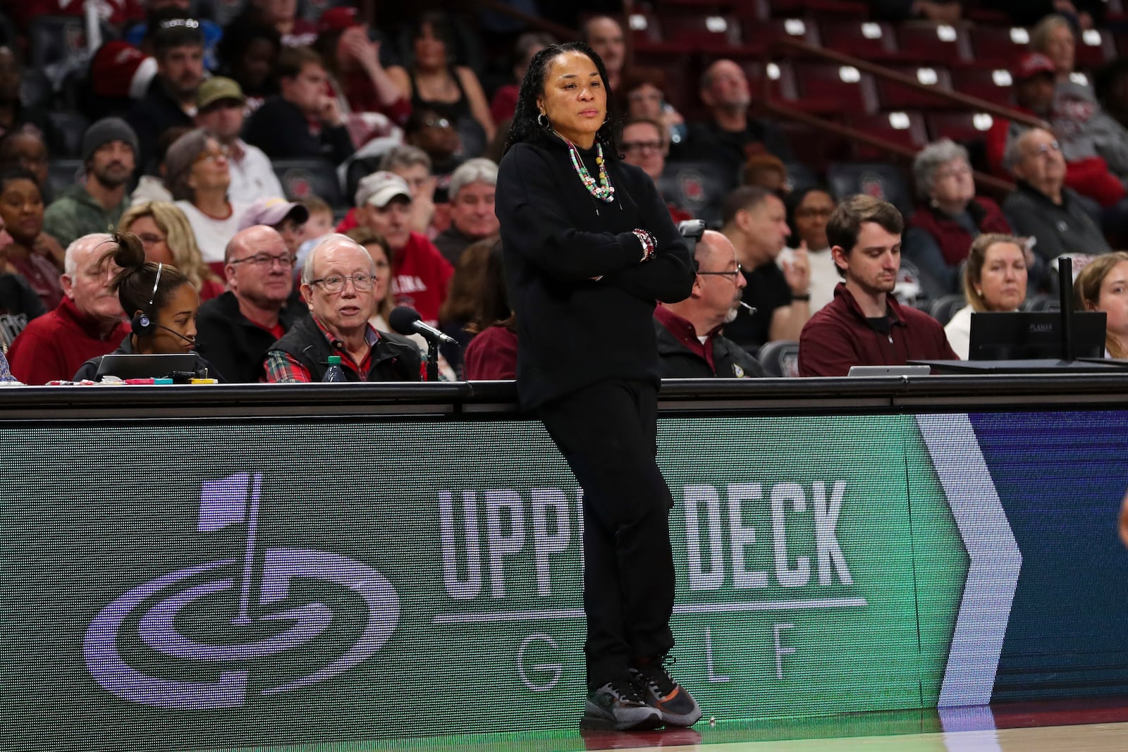 South Carolina head coach Dawn Staley, center, leans on the scorers table during the second half of an NCAA college basketball game against South Florida, Sunday, Dec. 15, 2024, in Columbia, S.C. (AP Photo/Artie Walker Jr.)