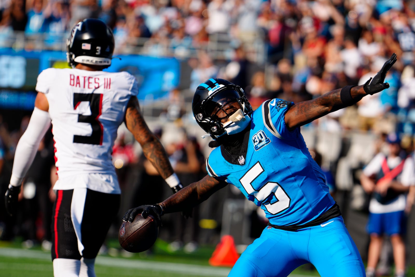 Carolina Panthers wide receiver Diontae Johnson (5) celebrates a touchdown in the first half of an NFL football game against the Atlanta Falcons in Charlotte, N.C., Sunday, Oct. 13, 2024. (AP Photo/Jacob Kupferman)