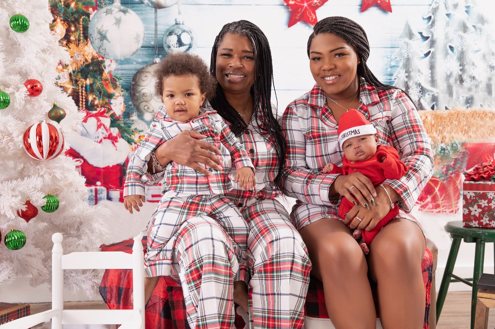 Rochelle Jones (left) holds her grandson Tru, while her daughter Tia Jones sits with her daughter Joi, as the family poses for their annual Christmas photos last year. Contributed photo 