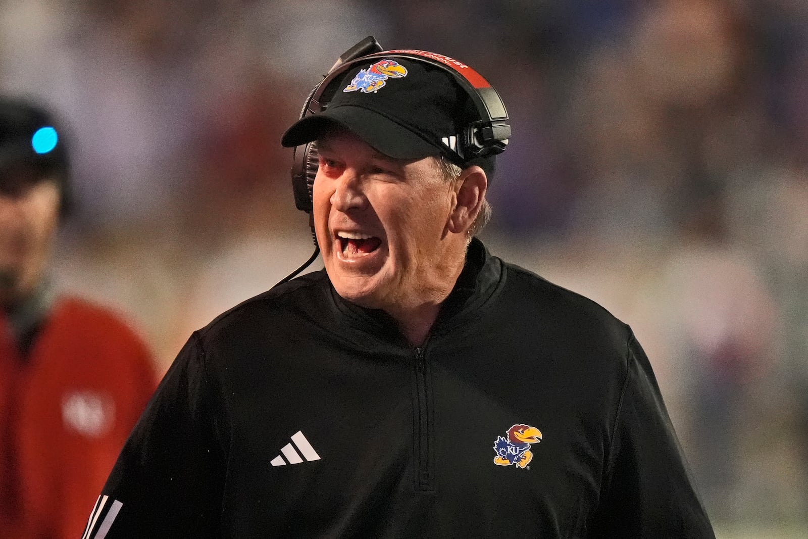 Kansas head coach Lance Leipold talks to an official during the first half of an NCAA college football game against Kansas State Saturday, Oct. 26, 2024, in Manhattan, Kan. (AP Photo/Charlie Riedel)