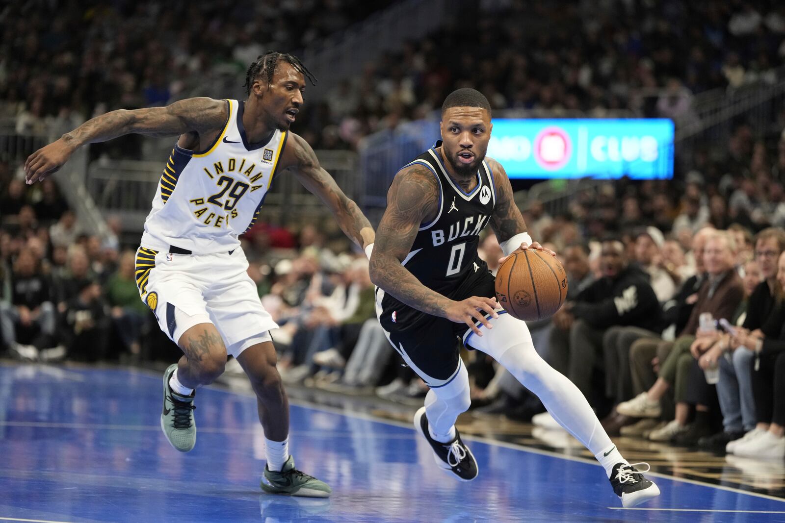 Milwaukee Bucks' Damian Lillard gets past Indiana Pacers' Quenton Jackson during the first half of an Emirates NBA cup tournament basketball game Friday, Nov. 22, 2024, in Milwaukee. (AP Photo/Morry Gash)