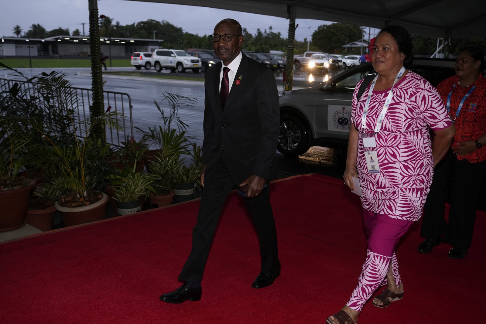 Mateus Magala, Mozambique's Minister of Transport and Communication, left, arrives for the official welcome reception for the Commonwealth Heads of Government meeting in Apia, Samoa, Thursday, Oct. 24, 2024. (AP Photo/Rick Rycroft/Pool)