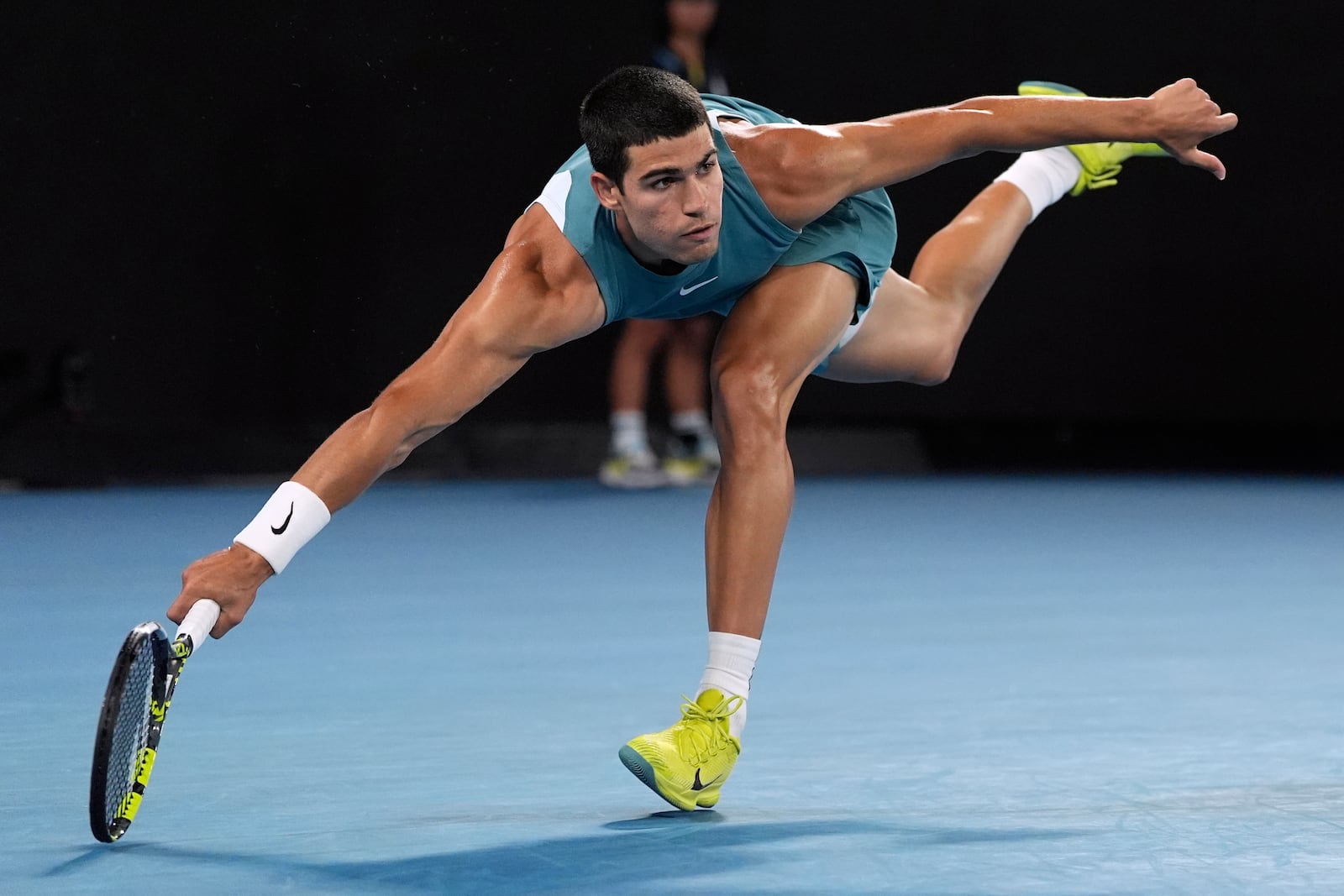 Carlos Alcaraz of Spain plays a forehand return to Novak Djokovic of Serbia during their quarterfinal match at the Australian Open tennis championship in Melbourne, Australia, Tuesday, Jan. 21, 2025. (AP Photo/Ng Han Guan)