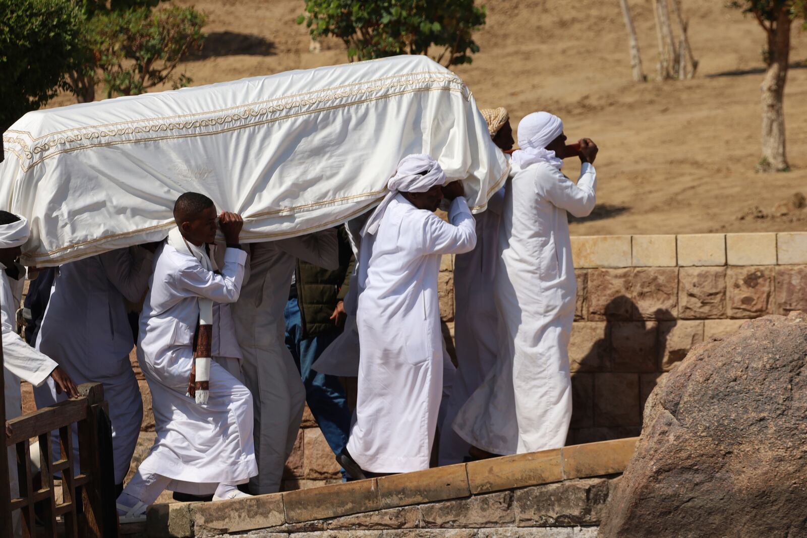 People carry the coffin of Prince Karim Al-Hussaini, the Aga Khan IV and 49th hereditary imam of the Shiite Ismaili Muslims, who died Tuesday in Portugal, to be buried at the Aga Khan mausoleum, in Aswan, Egypt, Sunday, Feb. 9, 2025. (AP Photo/Haytham Fahmy)