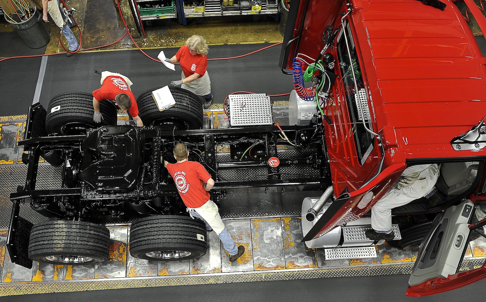 Navistar employees build a truck on the assembly line at Springfield plant. Bill Lackey/Staff