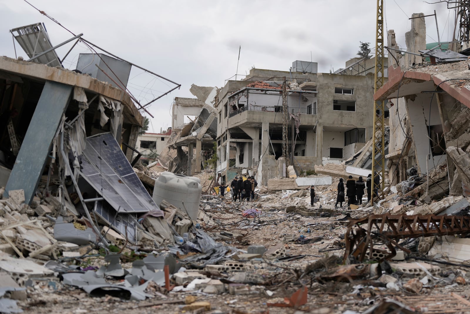 Lebanese citizens check the destruction on their village caused by the Israeli air and ground offensive, in Aita al-Shaab, a Lebanese border village with Israel, south Lebanon, Sunday, Jan. 26, 2025. (AP Photo/Bilal Hussein)