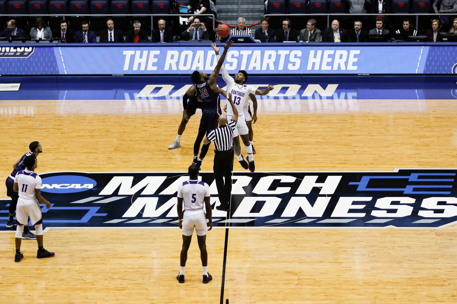 FILE - In this March 19, 2019, file photo, Fairleigh Dickinson's Kaleb Bishop (12) and Prairie View A&M's Iwin Ellis (13) leap for the opening tip-off in the first half of a First Four game of the NCAA college basketball tournament in Dayton. (AP Photo/John Minchillo, File)