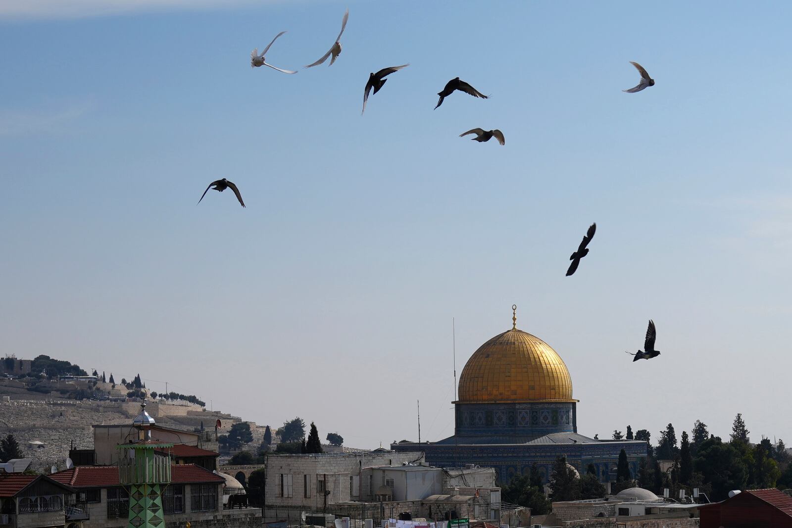 Birds fly above the Dome of the Rock Mosque in the Al-Aqsa Mosque compound in the Old City of Jerusalem, Tuesday, Jan. 28, 2025. (AP Photo/Mahmoud Illean)