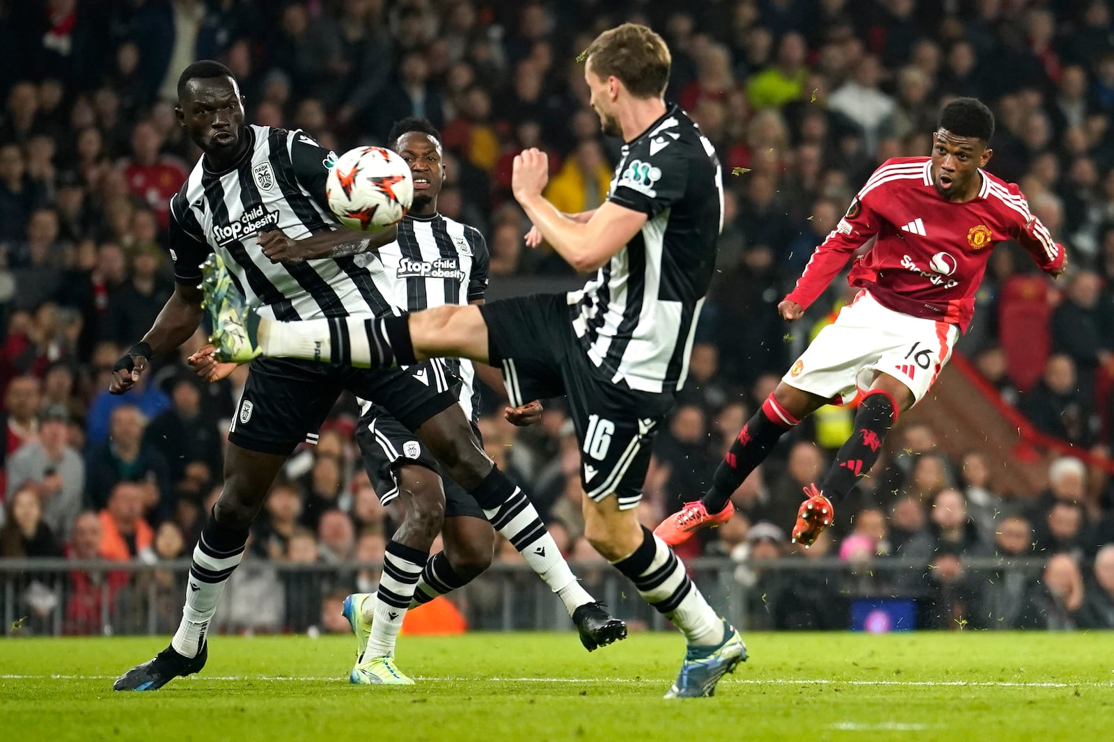 Manchester United's Amad Diallo, right, scores his side's second goal during the Europa League opening phase soccer match between Manchester United and PAOK at the Old Trafford stadium in Manchester, England, Thursday, Nov. 7, 2024. (AP Photo/Dave Thompson)