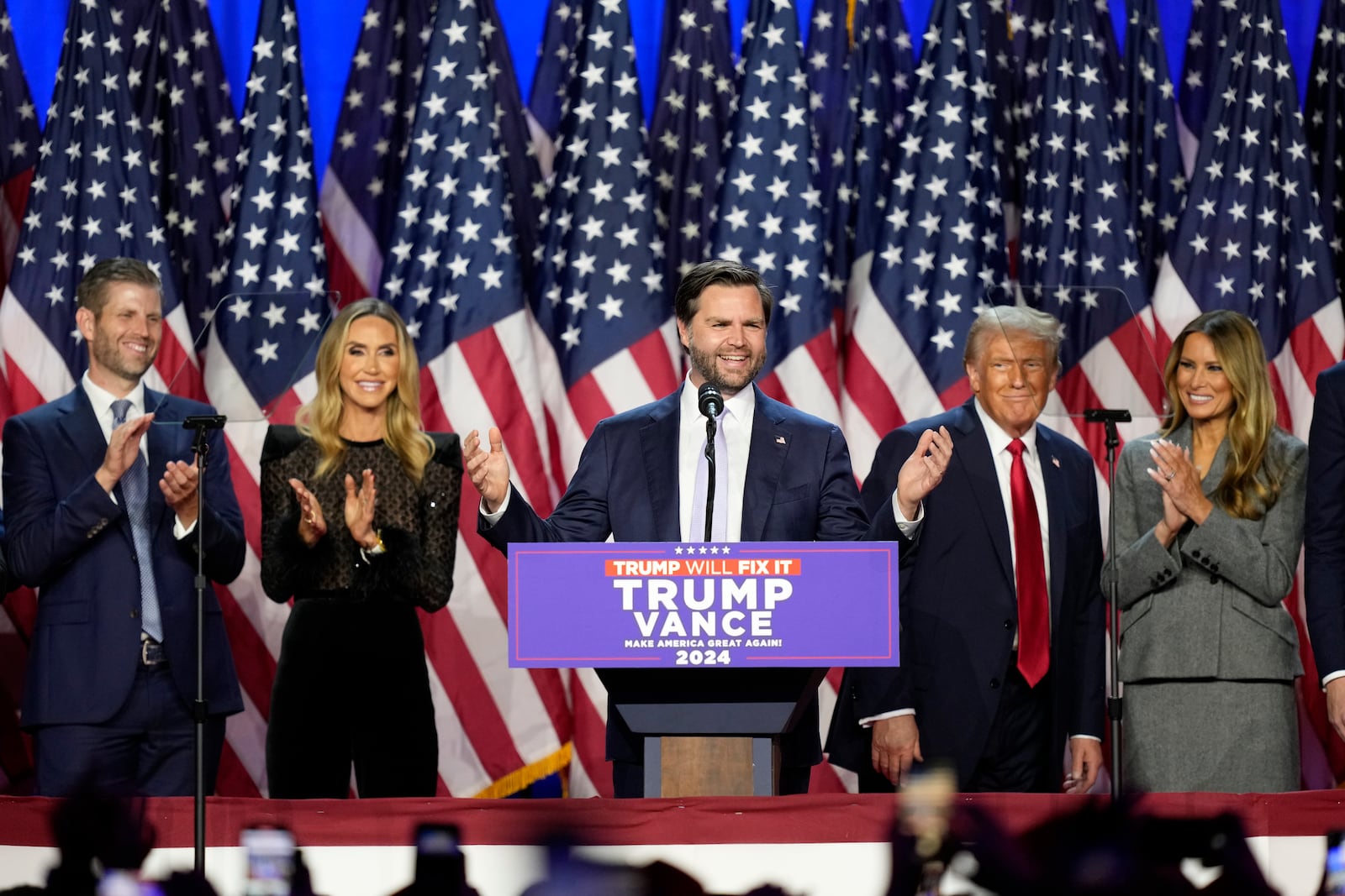 Republican vice presidential nominee Sen. JD Vance, R-Ohio, speaks as Eric Trump, from left, Lara Trump, Republican presidential nominee former President Donald Trump and former first lady Melania Trump look on at an election night watch party, Wednesday, Nov. 6, 2024, in West Palm Beach, Fla. (AP Photo/Alex Brandon)