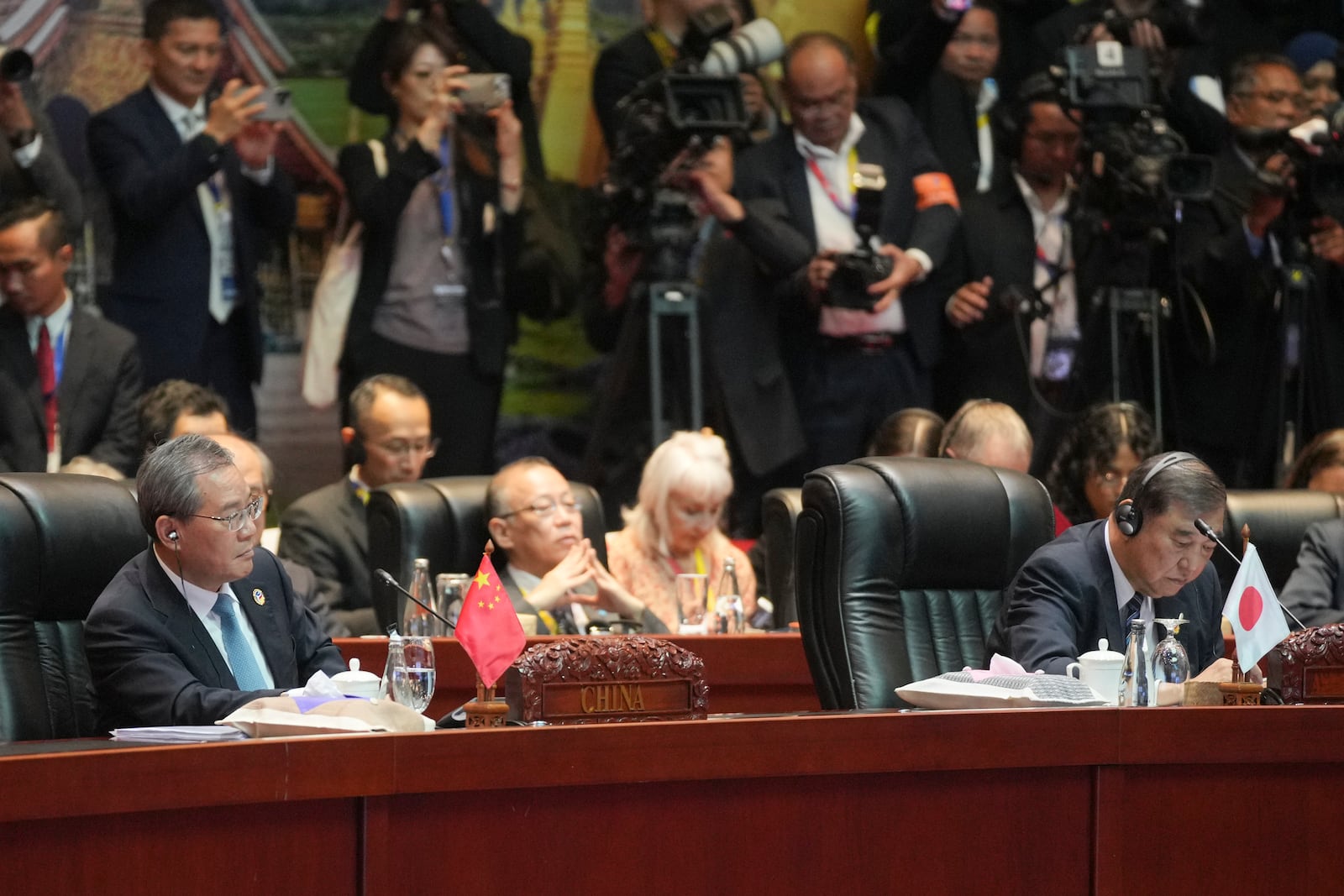 Chinese Premier Li Qiang, left seated, listens beside Japanese Prime Minister Shigeru Ishiba, right seated, during the 19th East Asia Summit in Vientiane, Laos, Friday, Oct. 11, 2024. (AP Photo/Dita Alangkara)