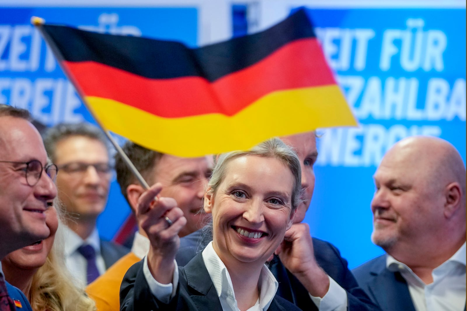 Leader of far right AfD Alice Weidel waves a German flag at the AfD party headquarters in Berlin, Germany, Sunday, Feb. 23, 2025, after the German national election. (AP Photo/Michael Probst)