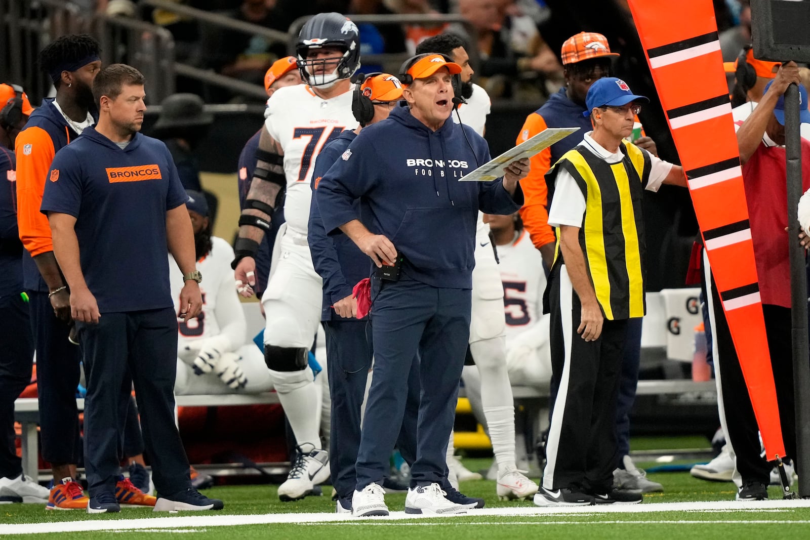 Denver Broncos head coach Sean Payton watches from the sideline during the first half of an NFL football game against the New Orleans Saints, Thursday, Oct. 17, 2024, in New Orleans. (AP Photo/Gerald Herbert)