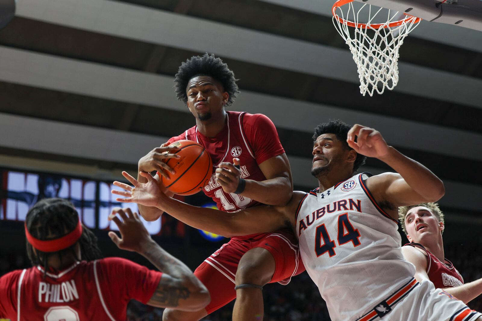 Alabama forward Mouhamed Dioubate (10) rebounds the ball with tight pressure from Auburn's Dylan Cardwell (44) during the first half of an NCAA college basketball game, Saturday, Feb. 15, 2025, in Tuscaloosa, Ala. (AP Photo/Vasha Hunt)