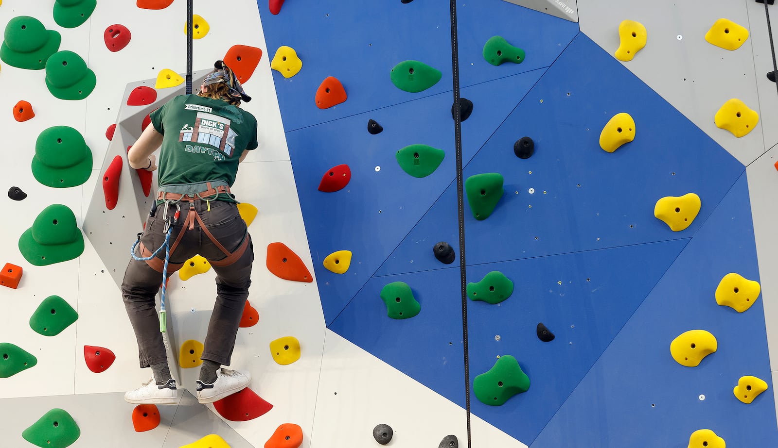 Staff member Aspen Goodwin safety-checks the rock climbing routes inside the new Dick's House of Sports at the Mall at Fairfield Commons. The grand opening was Friday, March 7, 2025. MARSHALL GORBY\STAFF