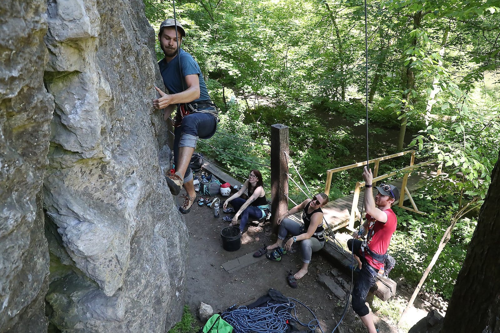 Jackson Pope works his way up a limestone cliff as he and his friends, from left, Emily Andrews, Mallory Hutton and Michael Barr rock climb at Mad River Gorge in this 2020 file photo. The site is managed by the Clark County Park District, which is considering a merger with the National Trail Parks and Recreation District. BILL LACKEY/STAFF