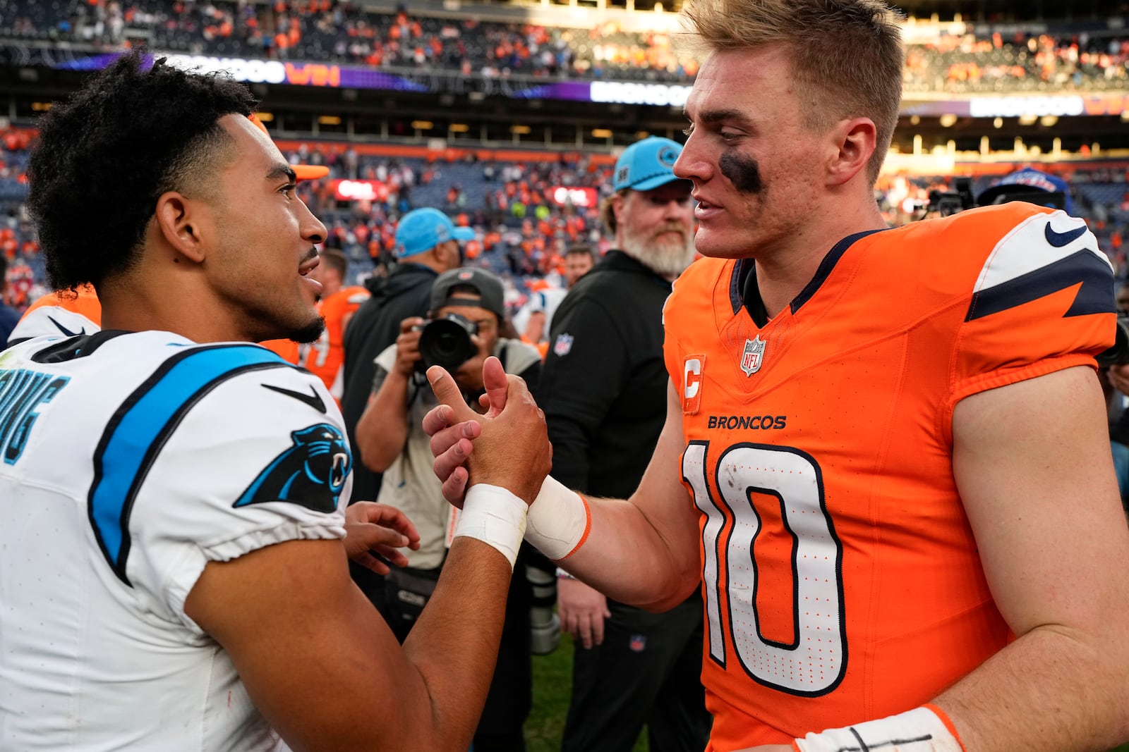 Carolina Panthers quarterback Bryce Young (9) shakes hands with Denver Broncos quarterback Bo Nix (10) after an NFL football game Sunday, Oct. 27, 2024, in Denver. (AP Photo/Jack Dempsey)