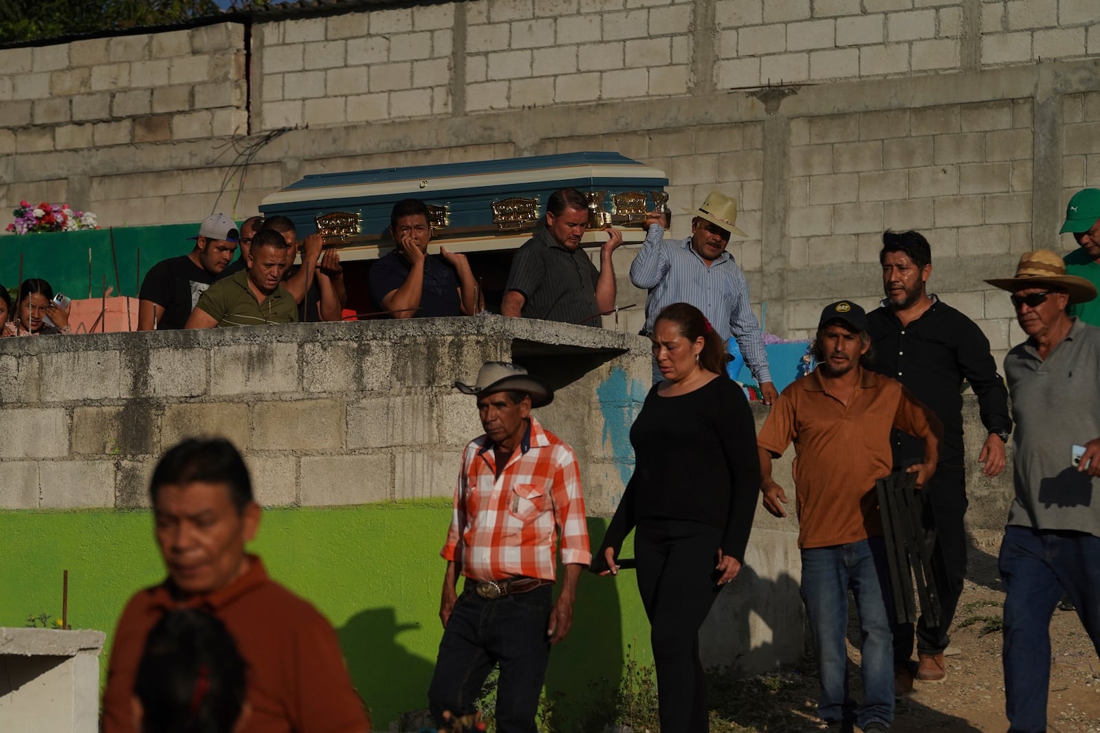 Pall bearers carry a coffin that contains the remains of a victim of a bus crash, to a cemetery for a burial service, in Santo Domingo Los Ocotes, Guatemala, Tuesday, Feb. 11, 2025. Dozens of passengers died after their bus plunged into a gorge and landed under a bridge on Feb. 10 on the outskirts of the Guatemalan capital. (AP Photo/Moises Castillo)