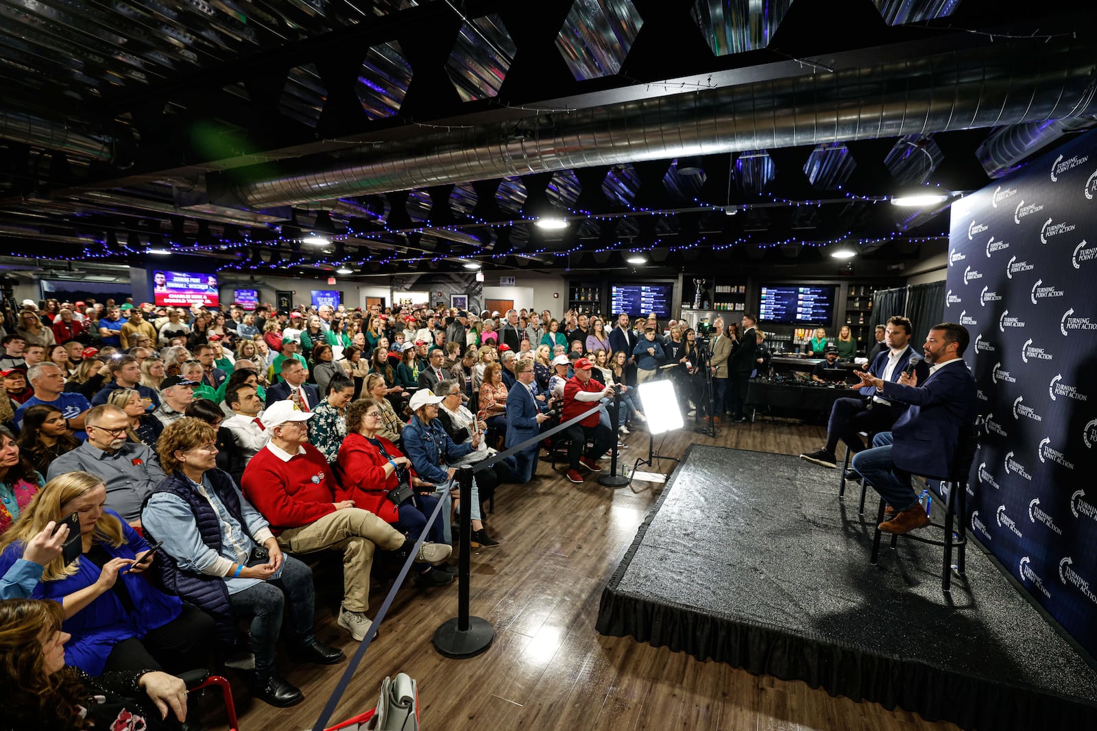 Donald Trump Jr. right and Charlie Kirk speak during a town hall meeting Monday, March 17, 2025, in Oconomowoc, Wis. (AP Photo/Jeffrey Phelps)