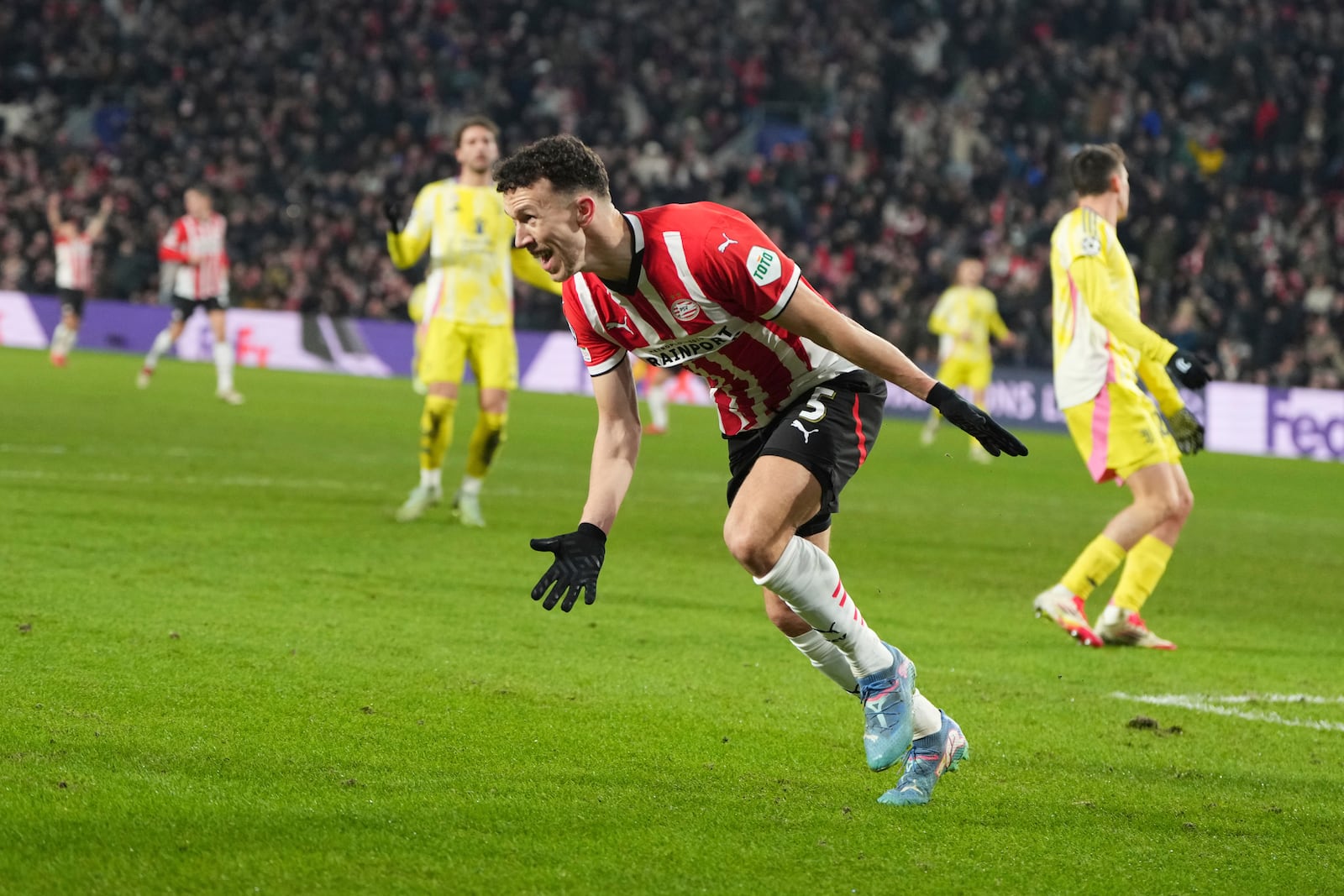 PSV's Ivan Perisic celebrates after scoring his side's opening goal during the Champions League playoff second leg soccer match between PSV and Juventus at Phillips Stadium in Eindhoven, Netherlands, Wednesday, Feb.19, 2025. (AP Photo/Peter Dejong)