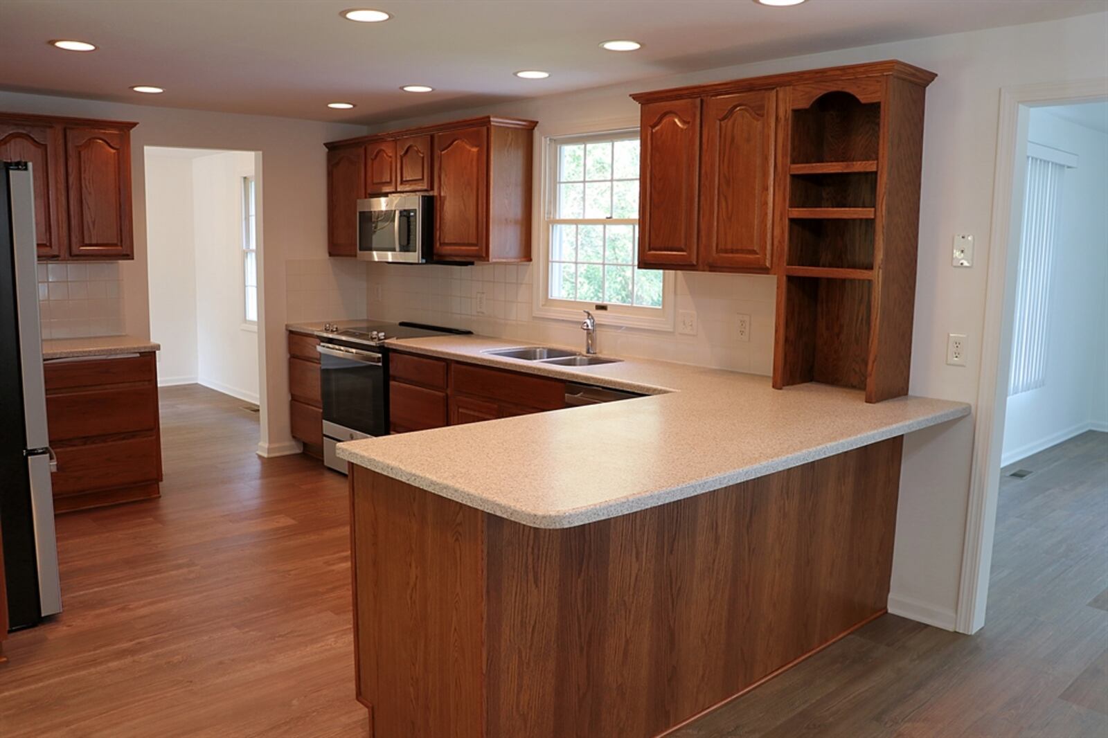 The updated kitchen has Corian counters on beautiful cabinetry that includes a pantry and a pullout lazy Susan within the peninsula counter. Contributed by Kathy Tyler 