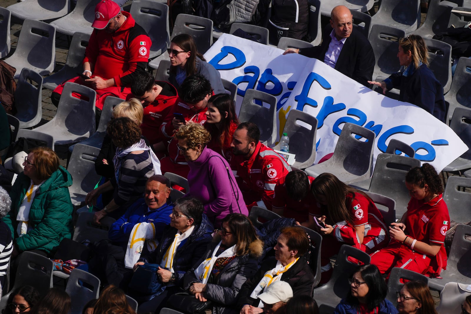 Faithful attend a mass celebrated by Cardinal Michael Czerny, prefect of the Dicastery for Promoting Integral Human Development, and delegate of Pope Francis for the members of the world of volunteers in St. Peter's Square at The Vatican, Sunday, March 9, 2025. (AP Photo/Gregorio Borgia)