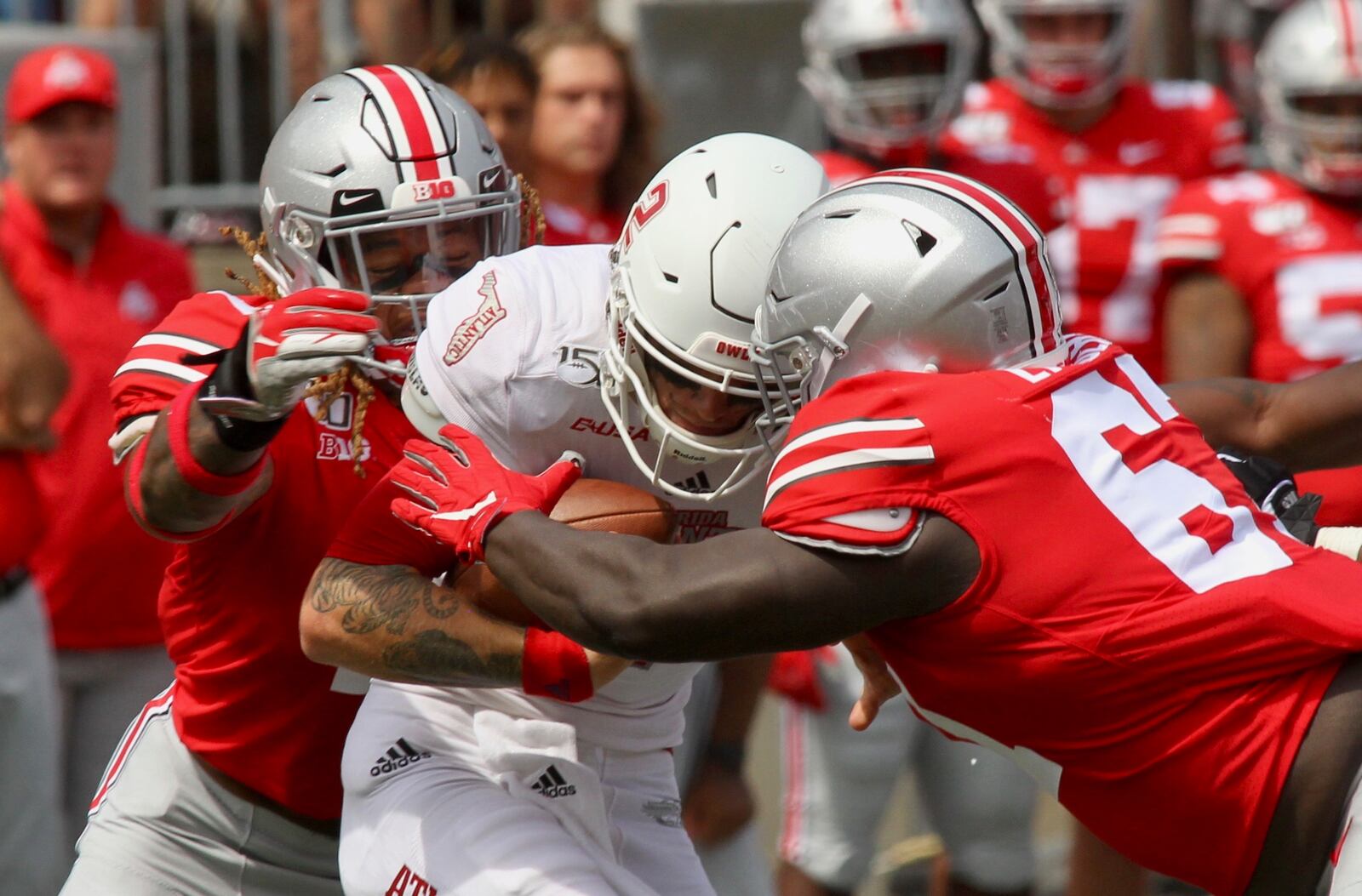 Ohio State’s Robert Landers, right, and Chase Young, left, record a sack against Florida Atlantic on Saturday, Aug. 31, 2019, at Ohio Stadium in Columbus.