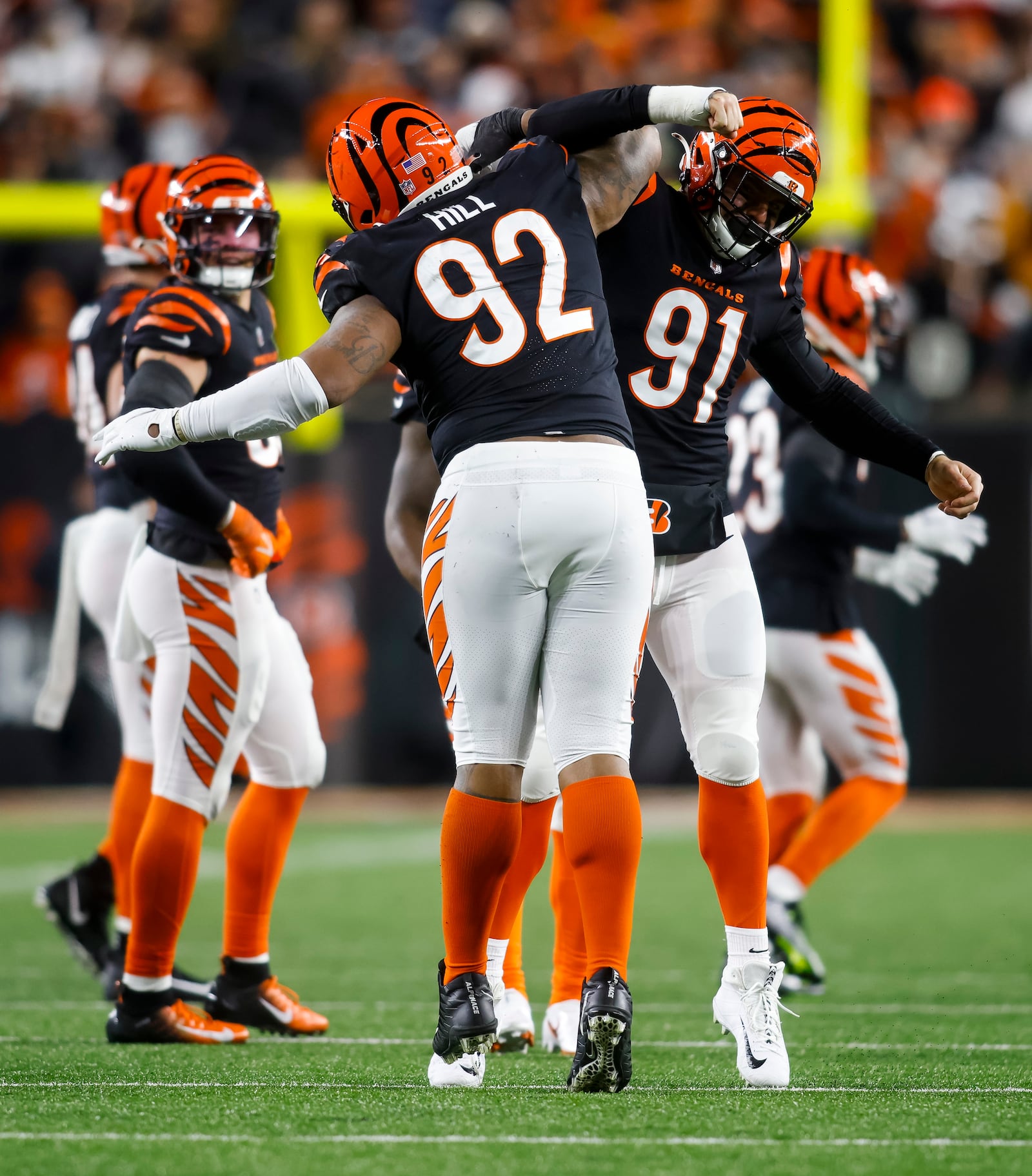 Bengals defensive tackle B.J. Hill (92) and defensive end Trey Hendrickson (91) celebrate a play during Cincinnati's AFC Wild Card playoff game against the Baltimore Ravens Sunday, Jan. 15, 2023 at Paycor Stadium in Cincinnati. The Bengals won 24-17. NICK GRAHAM/STAFF