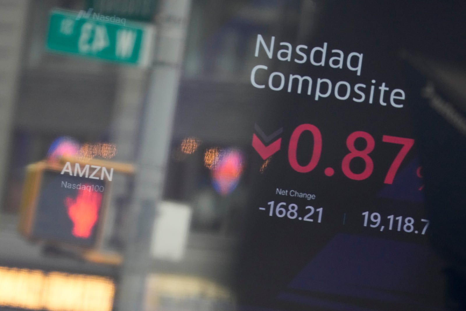 Signage in Times Square is reflected in the windows of the Nasdaq MarketSite in New York, Tuesday, Feb. 25, 2025. (AP Photo/Seth Wenig)