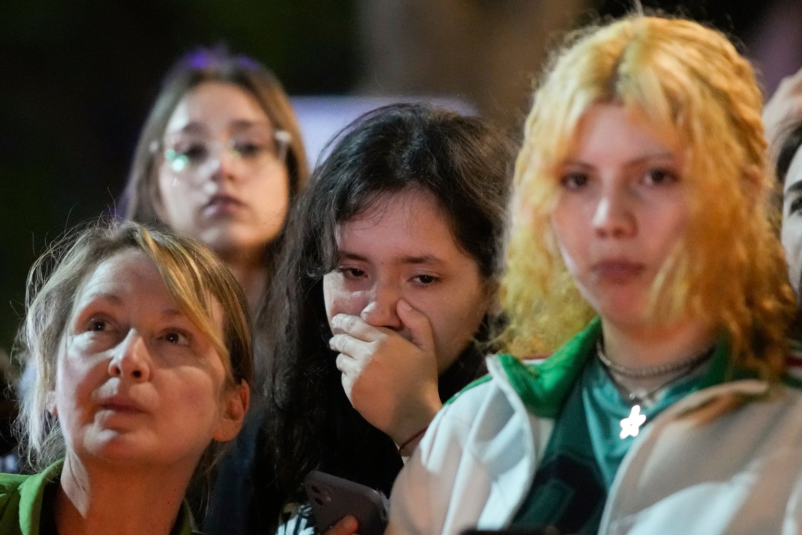 People gather outside the hotel where former One Direction singer Liam Payne was found dead after he fell from a balcony in Buenos Aires, Argentina, Wednesday, Oct. 16, 2024. (AP Photo/Natacha Pisarenko)