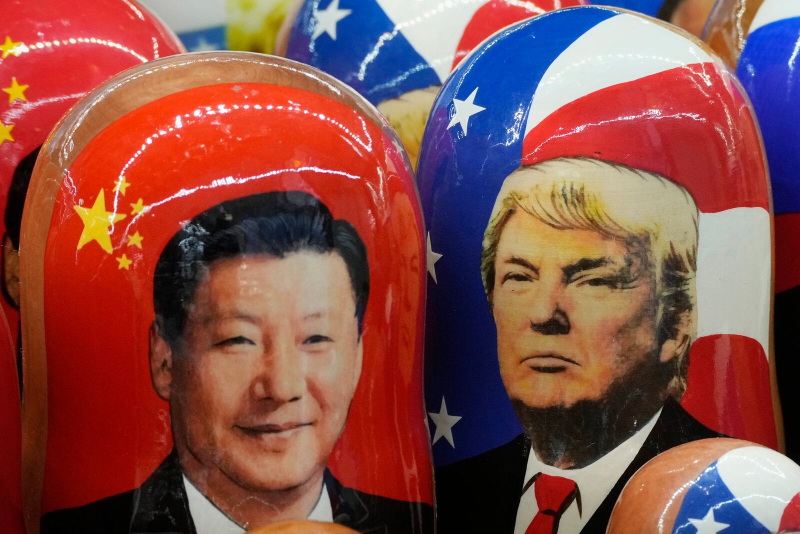 FILE - Traditional Russian wooden dolls called Matryoshka depicting China's President Xi Jinping, left, and U.S. President Donald Trump are on sale at a souvenir shop in St. Petersburg, Russia, on Nov. 21, 2024. (AP Photo/Dmitri Lovetsky, File)