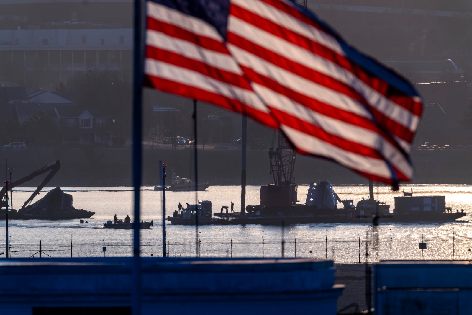 Salvage crews work near the wreckage site in the Potomac River of a mid-air collision between an American Airlines jet and a Black Hawk helicopter, at Ronald Reagan Washington National Airport, Tuesday, Feb. 4, 2025, in Arlington, Va. (AP Photo/Ben Curtis)