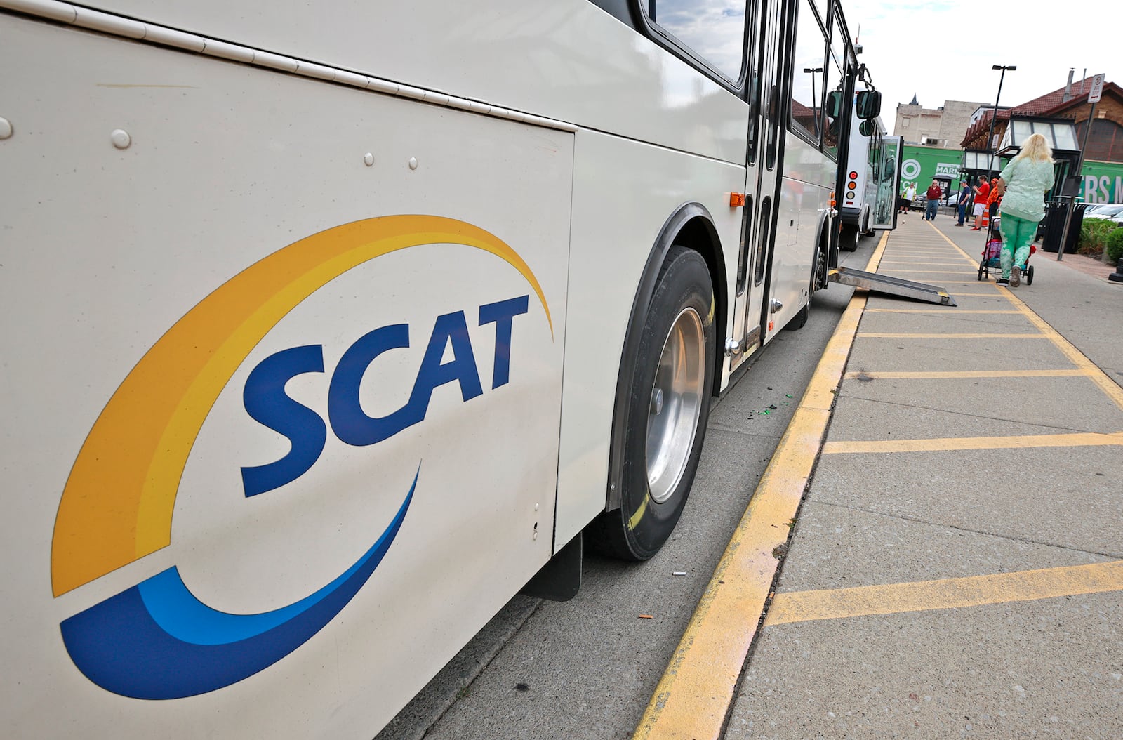 People get on and off the SCAT buses at the transit hub in downtown Springfield on Thursday, August 15, 2024. BILL LACKEY/STAFF