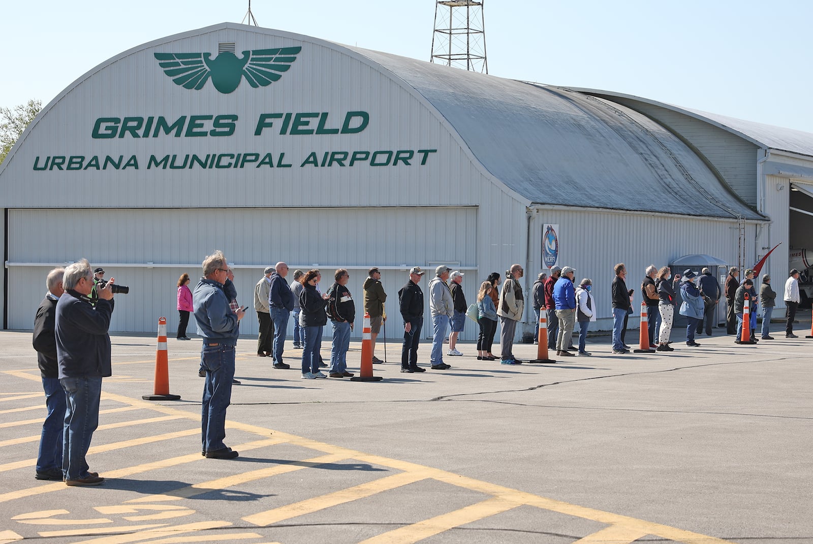 A crowd gathers to watch the "That's All, Brother," C-47 airplane land at Grimes Field in Urbana in April. BILL LACKEY/STAFF