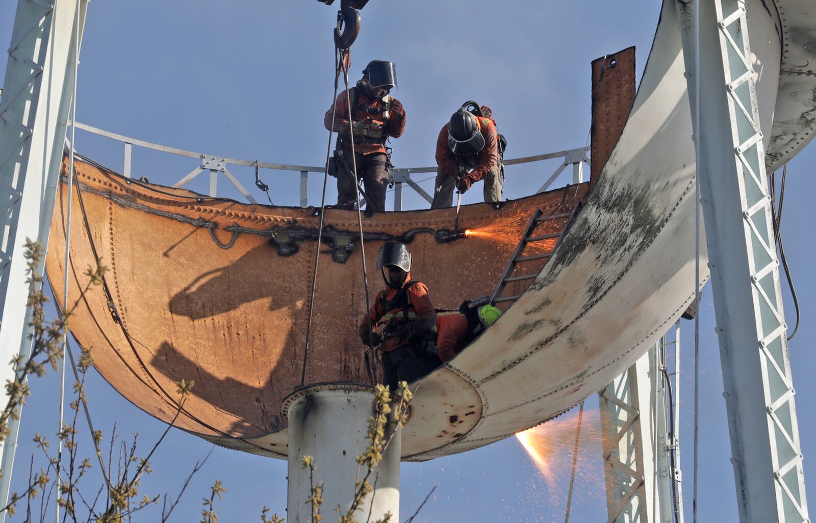 A demolition team made short work of the old Adams Water Tower in New Carlisle Monday morning. The team used cutting torches to chop the tower into large pieces and a crane lowered them to the ground where another crew cut them into smaller pieces. Several New Carlisle residents gathered along Adams Street to watch the nearly 100-year-old landmark come down.