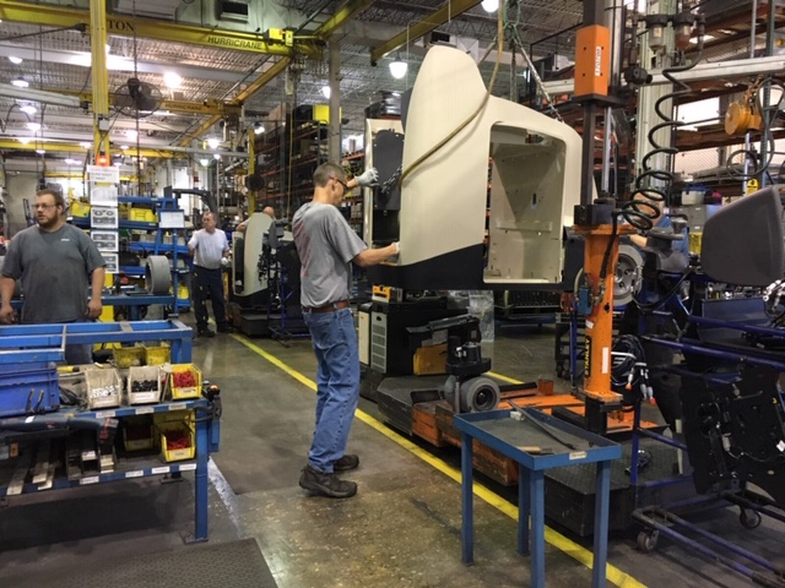 The chassis of a Crown vehicle is readied to be fitted over a power plant on a Crown assembly line in New Bremen. THOMAS GNAU/STAFF