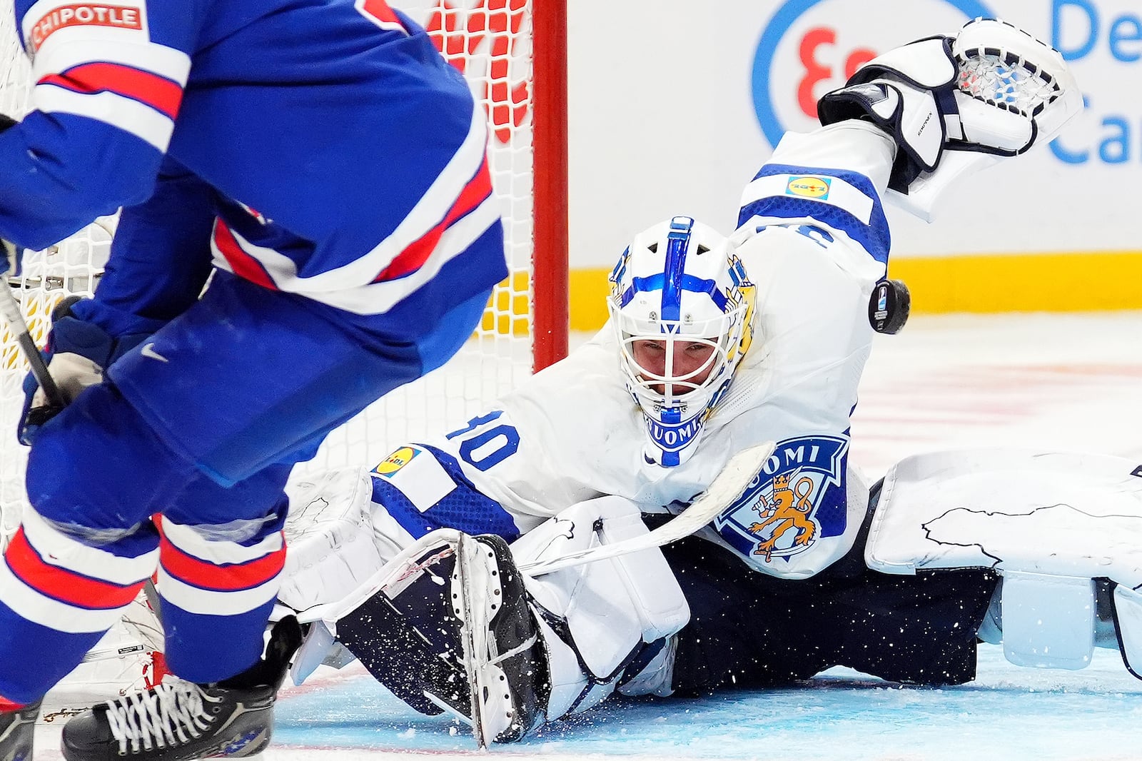 Finland goaltender Petteri Rimpinen, right, makes a save against United States forward Ryan Leonard during third-period IIHF World Junior Hockey Championship gold medal game action in Ottawa, Ontario, Sunday, Jan. 5, 2025. (Sean Kilpatrick/The Canadian Press via AP)