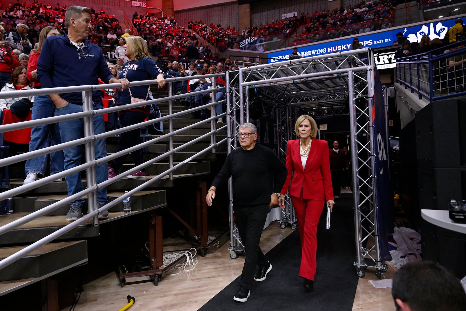 UConn head coach Geno Auriemma and associate head coach Chris Dailey enter a pregame ceremony honoring them, Wednesday, Nov. 20, 2024, in Storrs, Conn. (AP Photo/Jessica Hill)