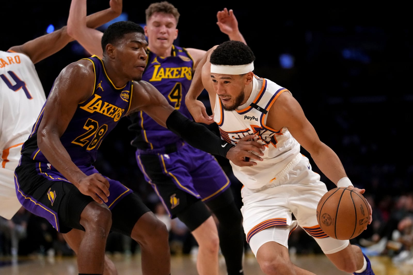 Phoenix Suns guard Devin Booker drives against Los Angeles Lakers forward Rui Hachimura (28) during the first half of an NBA basketball game against the in Los Angeles, Friday, Oct. 25, 2024. (AP Photo/Eric Thayer)