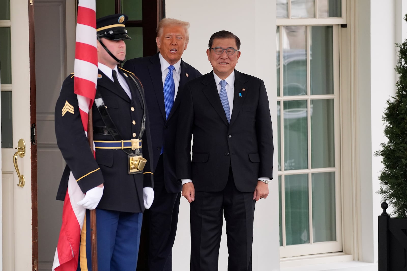 President Donald Trump, center, greets Japan's Prime Minister Shigeru Ishiba, right, at the White House, Friday, Feb. 7, 2025, in Washington. (AP Photo/Evan Vucci)