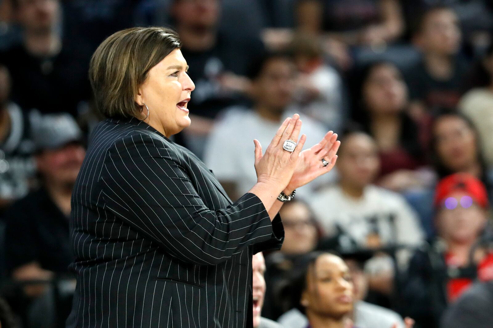 Dallas Wings head coach Latricia Trammell applauds a play during the first half of an WNBA basketball game against the Las Vegas Aces, Thursday, Sept. 19, 2024, in Las Vegas. (Steve Marcus/Las Vegas Sun via AP)