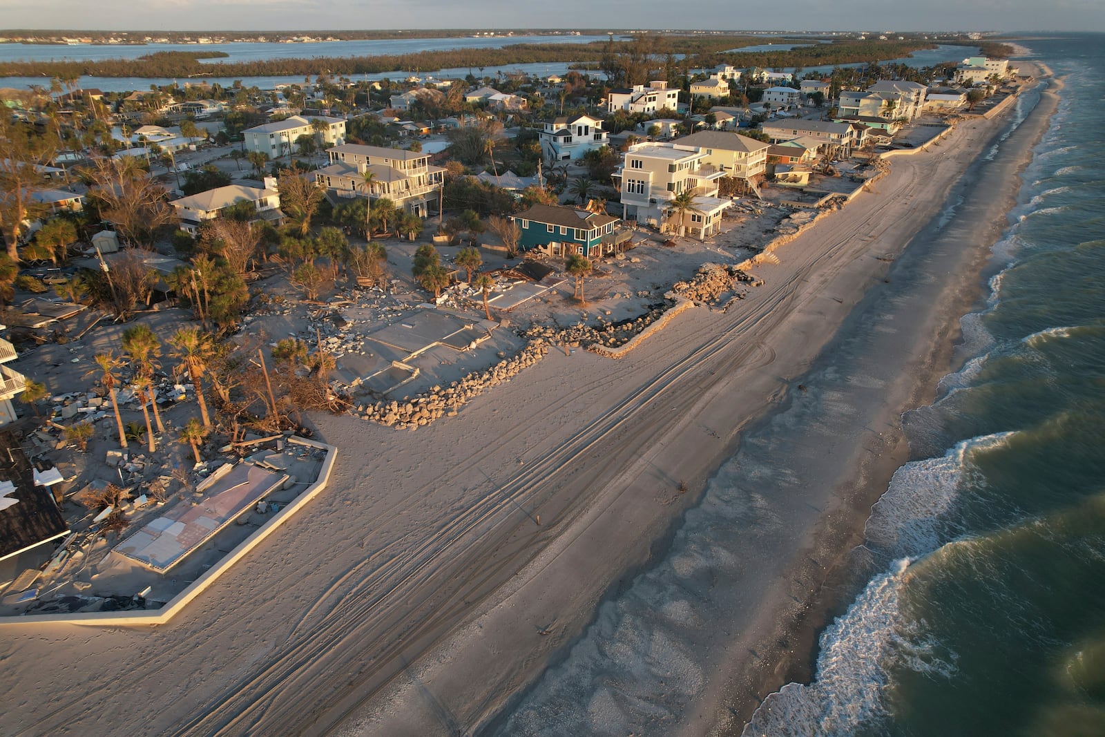 Waves roll in from the Gulf of Mexico toward lots where only empty foundations and debris remain after homes were swept away in Hurricane Milton, on Manasota Key in Englewood, Fla., Sunday, Oct. 13, 2024. (AP Photo/Rebecca Blackwell)