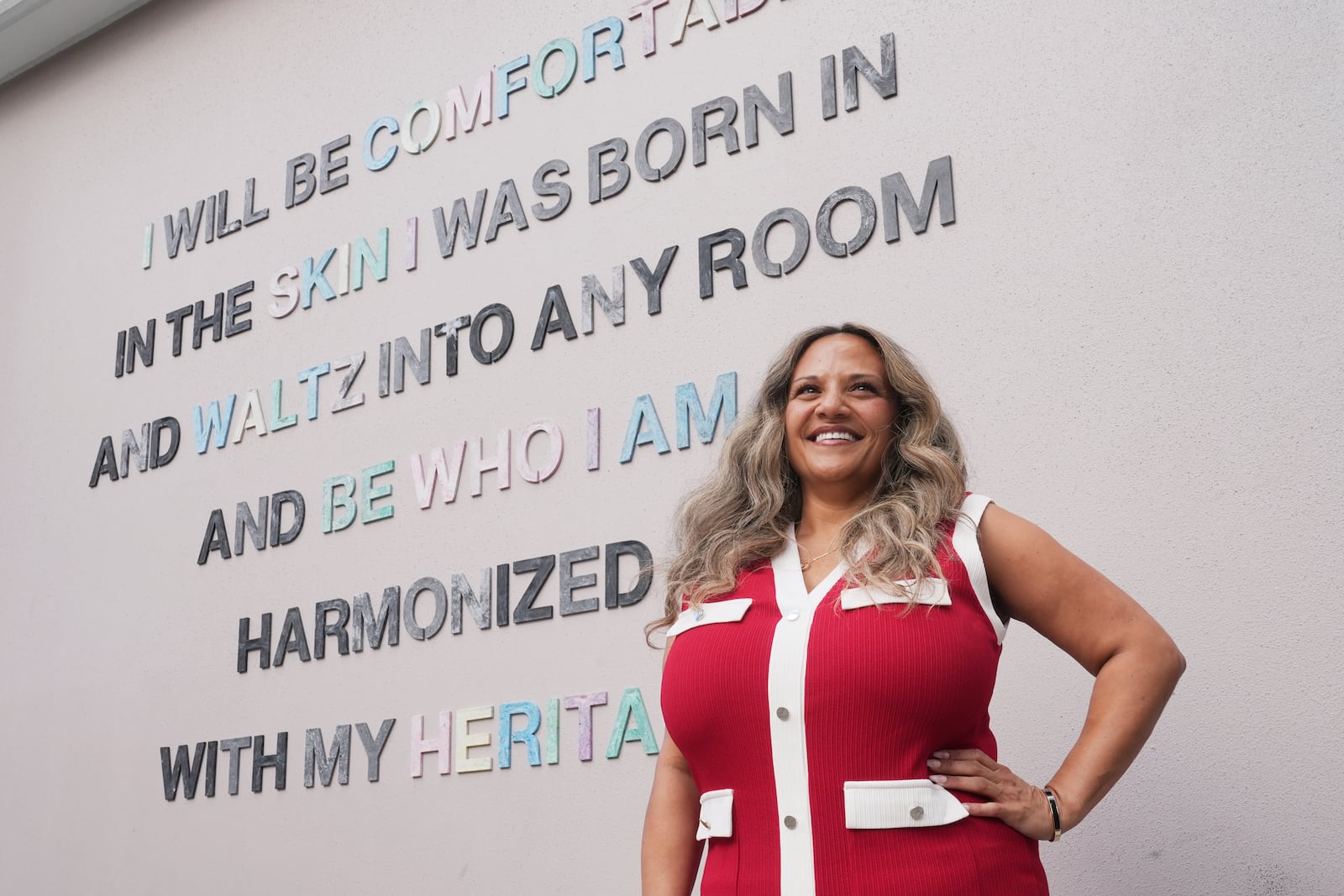 Renee O'Connor near a mural at Miami Norland Senior High School, Thursday, Dec. 19, 2024, in Miami Gardens, Fla. (AP Photo/Marta Lavandier)