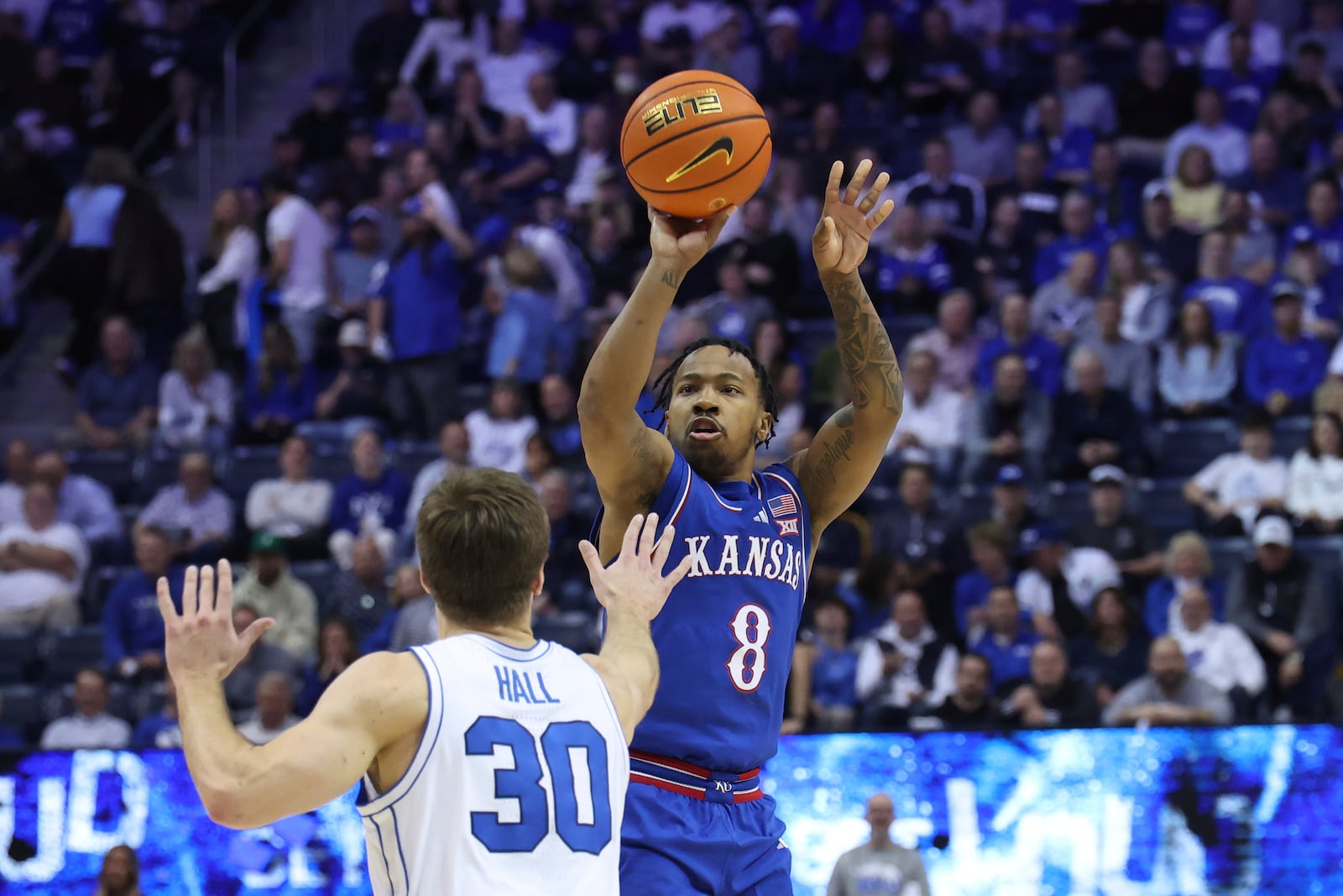 Kansas guard David Coit (8) shoots over BYU guard Dallin Hall (30) during the second half of an NCAA college basketball game Tuesday, Feb. 18, 2025, in Provo, Utah. (AP Photo/Rob Gray)