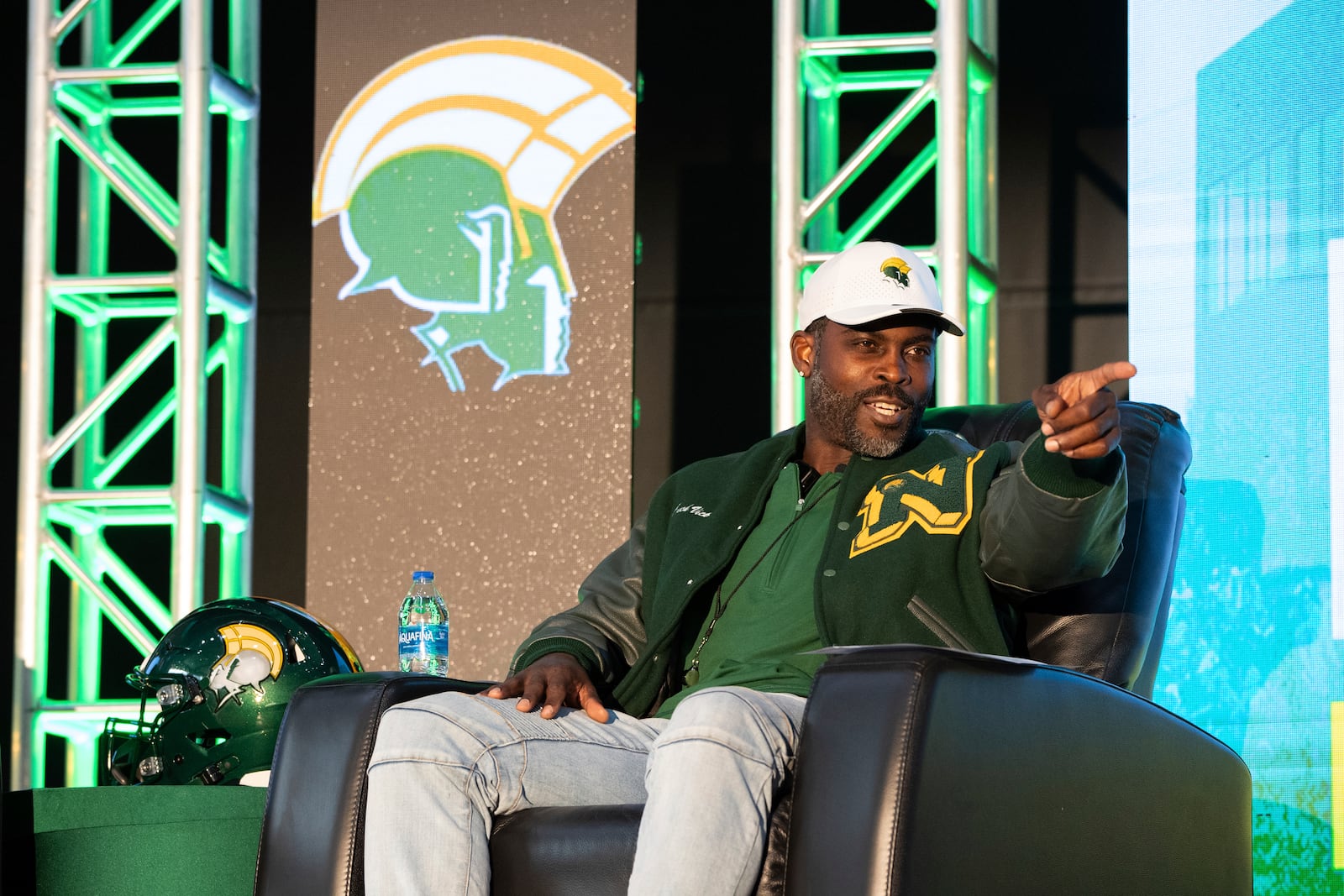 Michael Vick sits and answers questions from media and attendees durning a press conference on Monday, Dec. 23, 2024 in Norfolk, Va. (AP Photo/Mike Caudill)