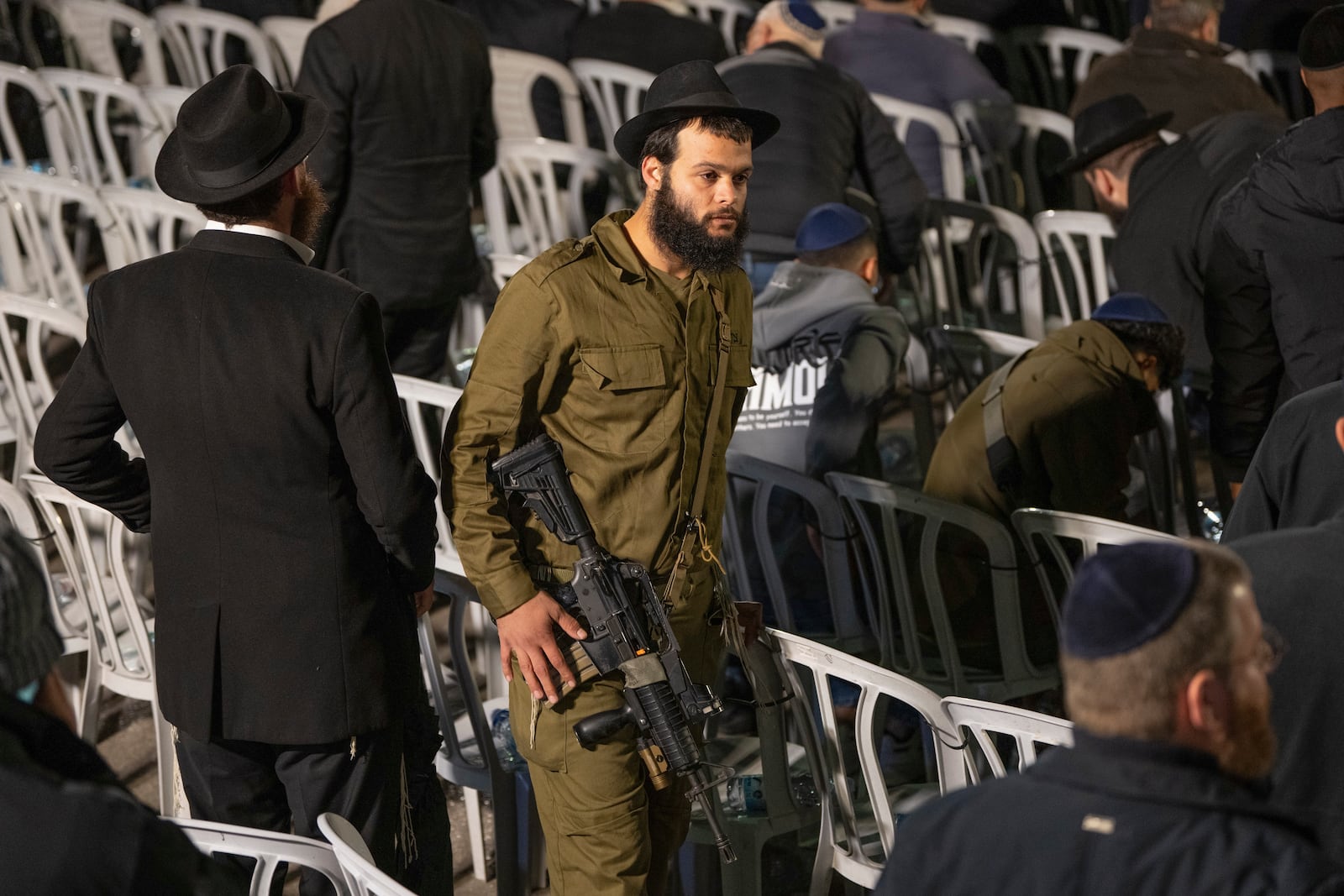 An Israeli soldier attends a ceremony prior to the funeral of Israeli-Moldovan rabbi Zvi Kogan in Kfar Chabad, Israel, Monday Nov. 25, 2024. Kogan, 28, an ultra-Orthodox rabbi, was killed last week in Dubai where he ran a kosher grocery store. Israelis have flocked for commerce and tourism since the two countries forged diplomatic ties in the 2020 Abraham Accords.(AP Photo/Ohad Zwigenberg)