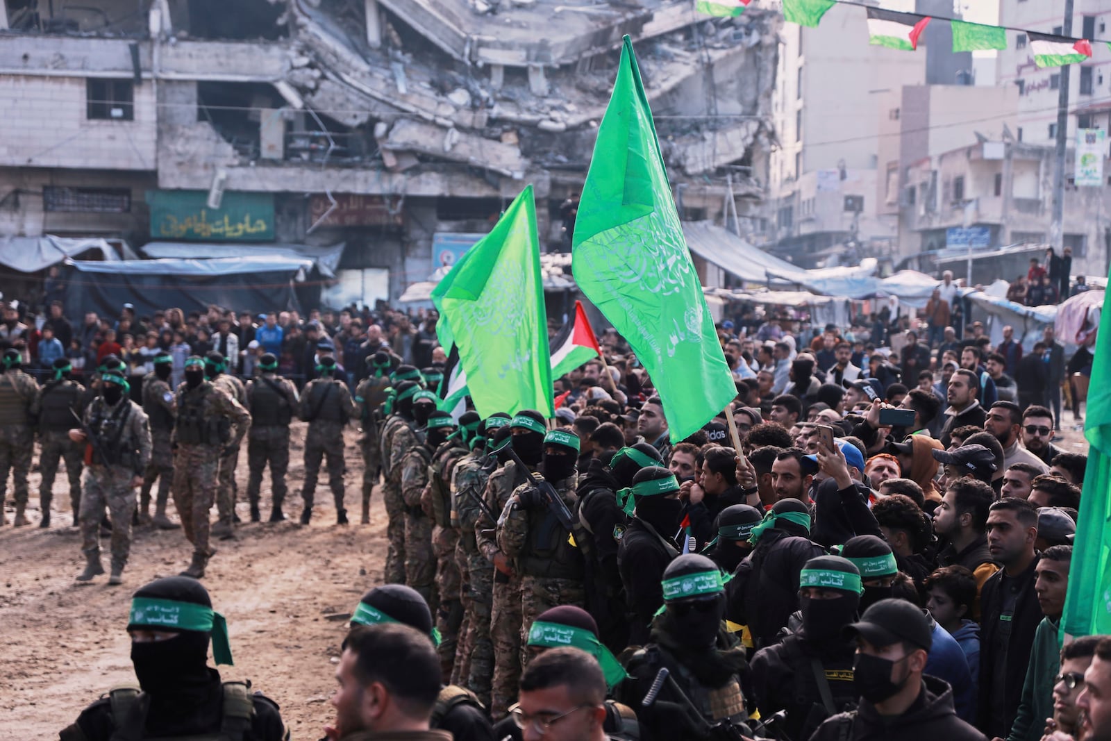 Hamas fighters are deployed in central Gaza City ahead of the planned release of four Israeli female hostages set to be handed over to the Red Cross in Gaza City on Saturday, Jan. 25, 2025. (AP Photo/Abed Hajjar)