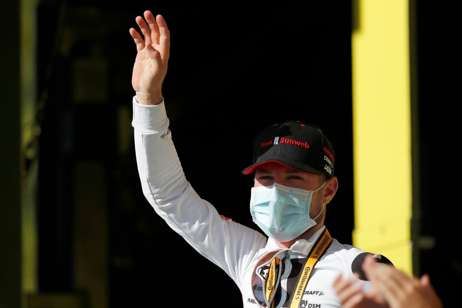 Switzerland's Marc Hirschi celebrates on the podium after winning the stage 12 of the Tour de France cycling race over 218 kilometers from Chauvigny to Sarran, Thursday, Sept. 10, 2020. (Sebastien Nogier/Pool photo via AP)