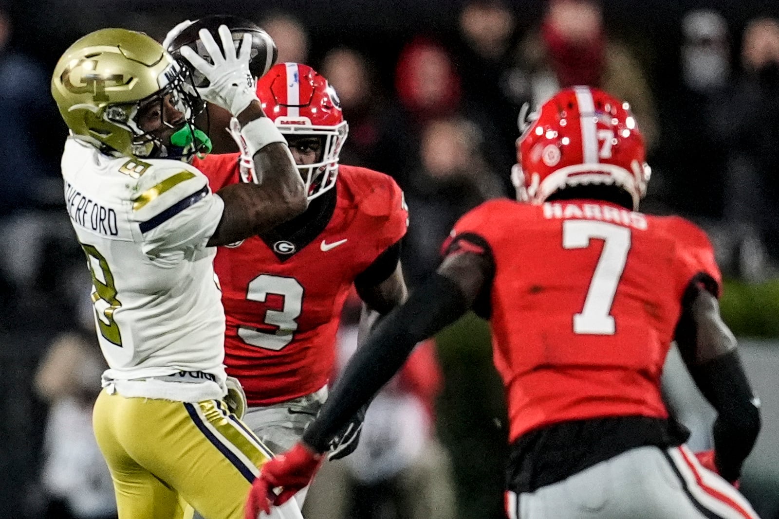 Georgia Tech wide receiver Malik Rutherford (8) makes the catch against Georgia defensive back Daniel Harris (7) during the first half of an NCAA college football game, Friday, Nov. 29, 2024, in Athens, Ga. (AP Photo/Mike Stewart)