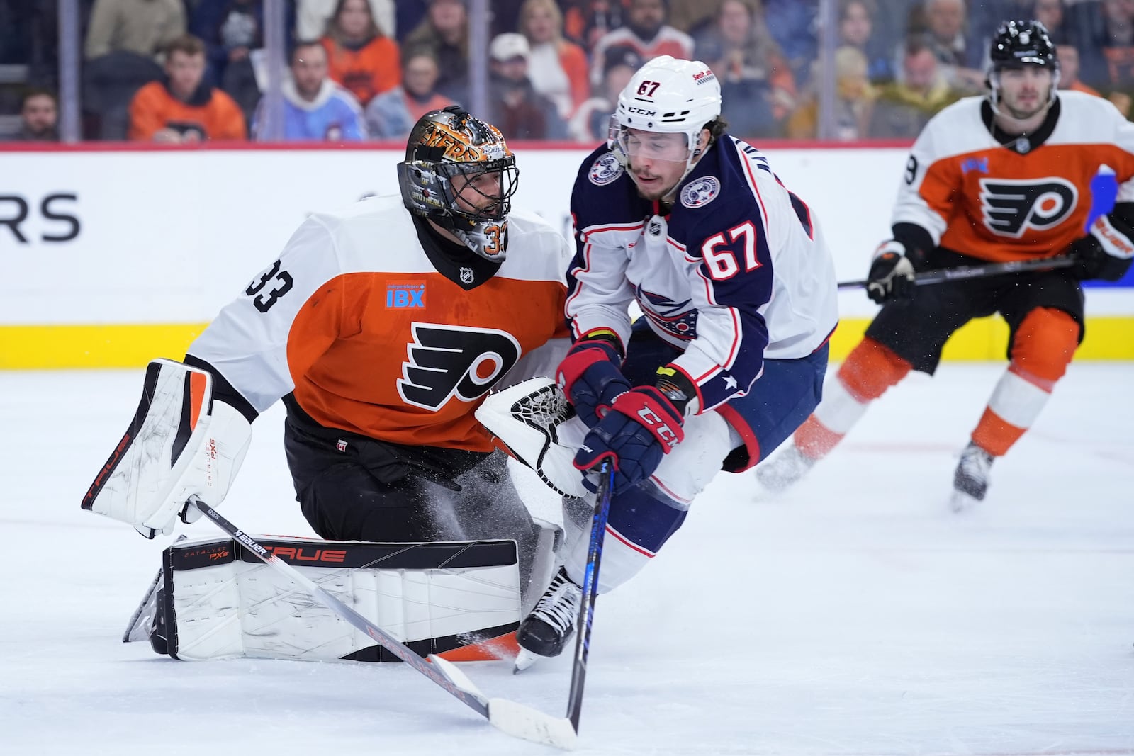 Columbus Blue Jackets' James Malatesta (67) collides with Philadelphia Flyers' Samuel Ersson (33) during the first period of an NHL hockey game, Saturday, Dec. 21, 2024, in Philadelphia. (AP Photo/Matt Slocum)